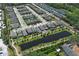 An aerial view of a planned community showcases the neighborhood with homes surrounding a pond at 4548 Dulwik Pl, Sanford, FL 32771