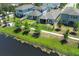 A view of a neighborhood with well-maintained lawns, serene pond, and a black metal fence, offering privacy at 4548 Dulwik Pl, Sanford, FL 32771