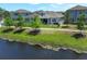 Backyard with a pond view, fenced-in yard, and a well-maintained lawn at 4548 Dulwik Pl, Sanford, FL 32771
