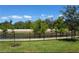 A tranquil backyard featuring lush greenery, a serene pond, and a sturdy black fence for privacy and security at 4548 Dulwik Pl, Sanford, FL 32771