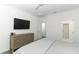 Well-lit bedroom with a large TV, dresser, and neutral color scheme for a relaxing atmosphere at 4548 Dulwik Pl, Sanford, FL 32771