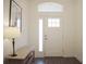 Bright entryway with wood-look floors, a stylish console table, and a front door with decorative window at 4548 Dulwik Pl, Sanford, FL 32771