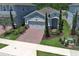 This single Gathering home has a well-manicured front lawn, brick paver driveway and two-car garage at 4548 Dulwik Pl, Sanford, FL 32771