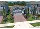 This single Gathering home has a well-manicured front lawn, brick paver driveway and two-car garage at 4548 Dulwik Pl, Sanford, FL 32771