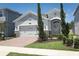 Charming single Gathering home with light colored stone accents, brick paver driveway, and arched entryway at 4548 Dulwik Pl, Sanford, FL 32771