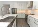 Bright and stylish kitchen with white cabinets, stainless steel appliances, a large island, and modern countertops at 4548 Dulwik Pl, Sanford, FL 32771