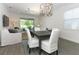 Open concept living space with ample seating, natural light, and seamless connection to the kitchen and dining area at 4548 Dulwik Pl, Sanford, FL 32771
