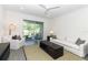 Comfortable living room showcasing stylish seating, a neutral color palette, and access to a private outdoor patio at 4548 Dulwik Pl, Sanford, FL 32771