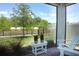 Relaxing screened patio featuring brick pavers, outdoor seating, and views of the landscaped backyard and pond at 4548 Dulwik Pl, Sanford, FL 32771