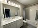 Bathroom features a double sink vanity with white cabinets, neutral walls, and shower-tub combination at 4828 Abbeywood Aly, Winter Garden, FL 34787