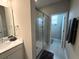 Bright bathroom with a glass enclosed shower, white cabinets, and tile floors at 4828 Abbeywood Aly, Winter Garden, FL 34787