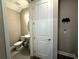 Neutral powder room featuring a pedestal sink, toilet, and simple decor for a clean aesthetic at 4828 Abbeywood Aly, Winter Garden, FL 34787