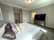 Comfortable bedroom boasts a large bed, plush carpet, and a view of the ensuite bathroom at 4828 Abbeywood Aly, Winter Garden, FL 34787