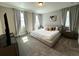 Bright, spacious bedroom features soft, natural light, plush carpet, and a comfortable platform bed at 4828 Abbeywood Aly, Winter Garden, FL 34787