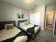 This bedroom features two beds with neutral walls, plus a closet and doorway at 4828 Abbeywood Aly, Winter Garden, FL 34787