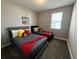 This bedroom features two beds with Disney decor, a window, and grey walls at 4828 Abbeywood Aly, Winter Garden, FL 34787