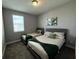 This bedroom features two beds, neutral walls, and a window that lets in natural light at 4828 Abbeywood Aly, Winter Garden, FL 34787