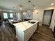 Open concept showcases kitchen island and dining area, offering a perfect layout for gathering at 4828 Abbeywood Aly, Winter Garden, FL 34787