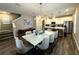 Bright, open-concept kitchen and dining area with modern lighting fixtures and neutral color palette at 4828 Abbeywood Aly, Winter Garden, FL 34787