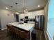 Kitchen island with sleek countertops, pendant lighting, and stainless steel appliances offering modern convenience at 4828 Abbeywood Aly, Winter Garden, FL 34787
