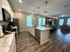 Bright, open kitchen with stainless steel appliances seamlessly connects to the dining and living areas at 4828 Abbeywood Aly, Winter Garden, FL 34787
