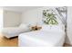 Bright bedroom with white linens, minimalist decor, two beds, and a nature-inspired print at 5245 W Irlo Bronson Memorial Hwy # 170, Kissimmee, FL 34746