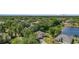 Overhead shot highlighting homes nestled among dense trees, close to a serene lake, perfect for peaceful living at 5494 Glen Oak Pl, Sanford, FL 32771