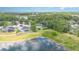 Expansive aerial view of a home nestled amongst lush greenery and serene lakefront scenery at 5494 Glen Oak Pl, Sanford, FL 32771