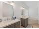 Bright bathroom with double vanity, quartz countertop, and a separate soaking tub at 5494 Glen Oak Pl, Sanford, FL 32771