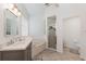 Bright bathroom featuring double vanity, quartz countertop and a separate glass enclosed shower at 5494 Glen Oak Pl, Sanford, FL 32771