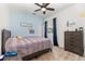 Comfortable bedroom featuring a full-size bed, blue curtains, and dresser at 5494 Glen Oak Pl, Sanford, FL 32771