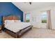 Comfortable bedroom features a king bed, white dresser, and blue accent wall at 5494 Glen Oak Pl, Sanford, FL 32771