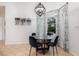 Bright breakfast nook featuring a modern chandelier, round glass-top table, and large window views at 5494 Glen Oak Pl, Sanford, FL 32771