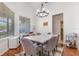 Elegant dining room features a marble table, modern lighting, and natural light from a large window at 5494 Glen Oak Pl, Sanford, FL 32771