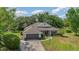 Charming single-story home featuring a well-maintained lawn, lush landscaping, and a two-car attached garage at 5494 Glen Oak Pl, Sanford, FL 32771