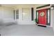 Charming covered front porch with swing, complemented by a red front door with decorative wreath at 5494 Glen Oak Pl, Sanford, FL 32771