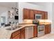 Well-equipped kitchen featuring stainless steel appliances, granite countertops, and warm wood cabinetry at 5494 Glen Oak Pl, Sanford, FL 32771
