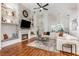 Bright open-concept living room featuring a fireplace, built-ins, and views to the dining area and kitchen at 5494 Glen Oak Pl, Sanford, FL 32771
