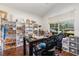 Spacious office with a large window, wooden desk, and custom shelving for storage at 5494 Glen Oak Pl, Sanford, FL 32771