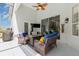 Covered patio with wicker seating, ceiling fan, outdoor lighting and a Welcome sign at 5494 Glen Oak Pl, Sanford, FL 32771