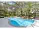 Screened-in pool area with mature trees and waterfall feature at 5494 Glen Oak Pl, Sanford, FL 32771