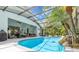 Screened-in pool with a rock waterfall feature and outdoor seating area at 5494 Glen Oak Pl, Sanford, FL 32771