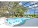 Screened-in pool area with a beautiful waterfall feature and lush tropical landscaping at 5494 Glen Oak Pl, Sanford, FL 32771