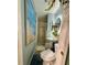Modern powder room showcasing a glass-enclosed shower and pedestal sink with blue walls and an ocean-themed artwork at 5501 Vance Ave, Orlando, FL 32810