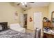 Cozy bedroom with a comfortable bed, white couch, and a ceiling fan at 5501 Vance Ave, Orlando, FL 32810