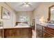 Comfortable bedroom with neutral color palette, wood furnishings, and natural light at 5501 Vance Ave, Orlando, FL 32810