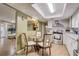 Eat-in kitchen features stainless steel appliances, white cabinets and tile backsplash at 5501 Vance Ave, Orlando, FL 32810