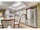 Bright eat-in kitchen featuring stainless steel appliances, white cabinets and tile backsplash at 5501 Vance Ave, Orlando, FL 32810