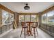 Sun room with block walls, large windows, tile floor, and table with seating at 5501 Vance Ave, Orlando, FL 32810