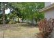 A spacious backyard features mature trees, providing shade and a serene environment at 622 Alton Rd, Winter Springs, FL 32708
